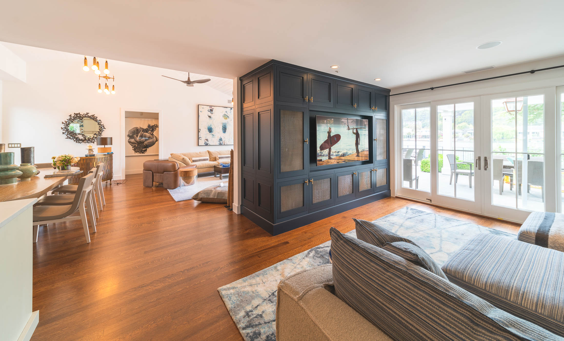 Open floor plan with a TV in a custom cabinet with home-wide audio in the ceiling