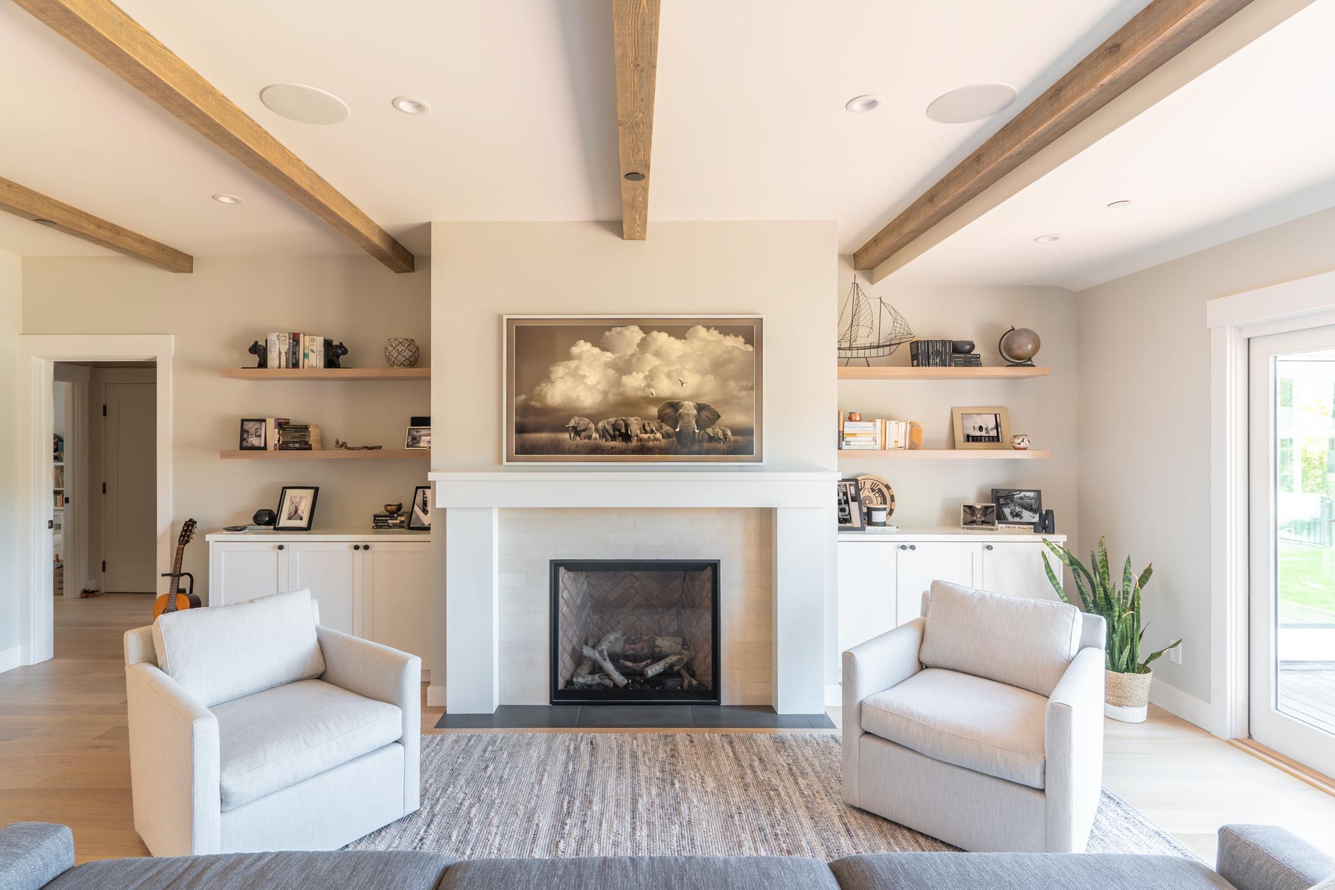 65" Frame TV displaying art – SoundVision 65" Samsung Frame TV above the fireplace displaying artwork. Viewed from the perspective on the couch.