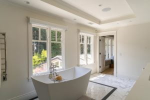 Lutron Sivoia shades by the tub in a master bathroom
