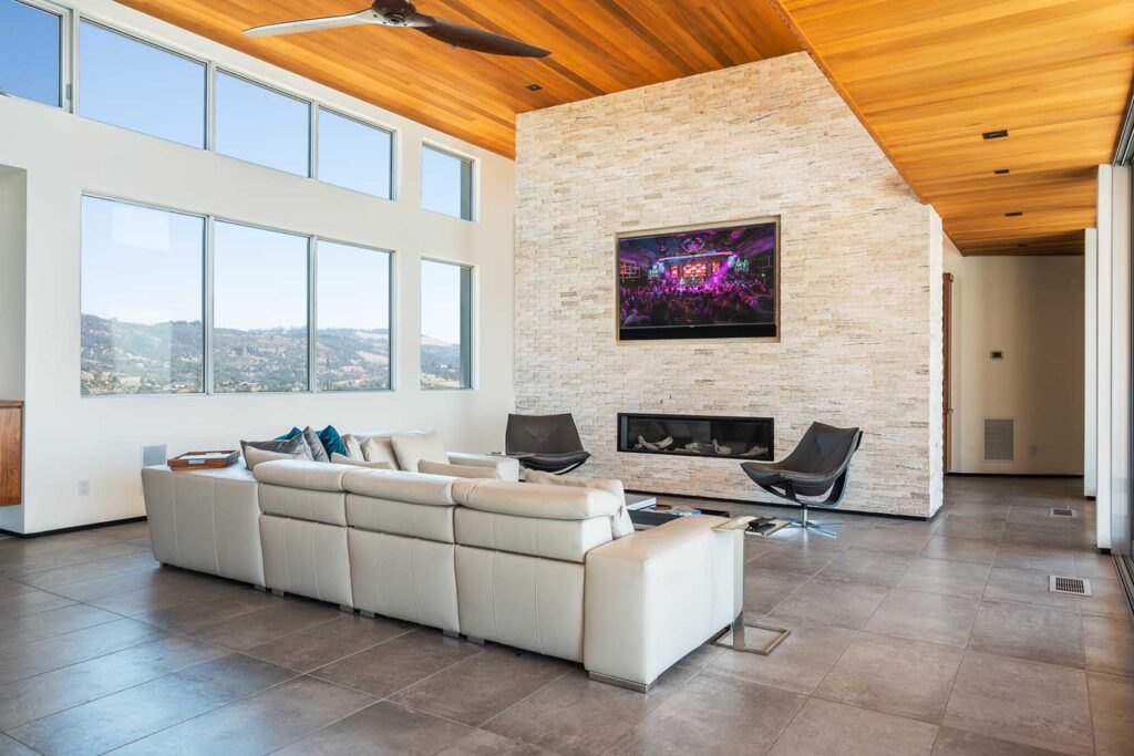 TV & Soundbar recessed in a light brick wall with a fireplace below.