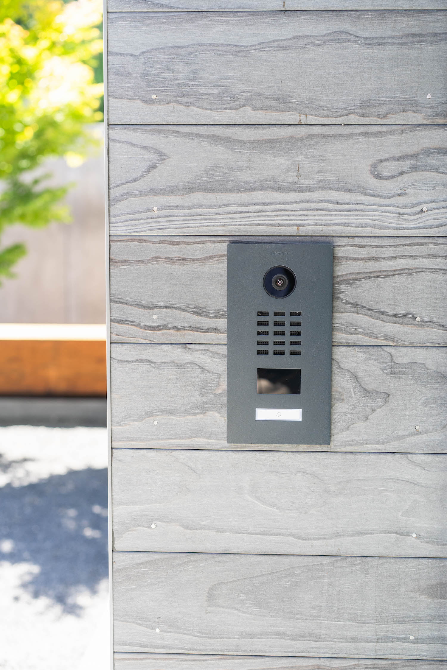 Doorbird intercom/smart doorbell mounted on the side of a home